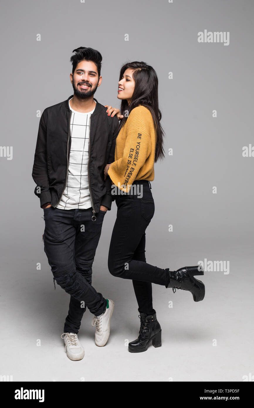 Full length portrait of a cheerful young couple standing together ...