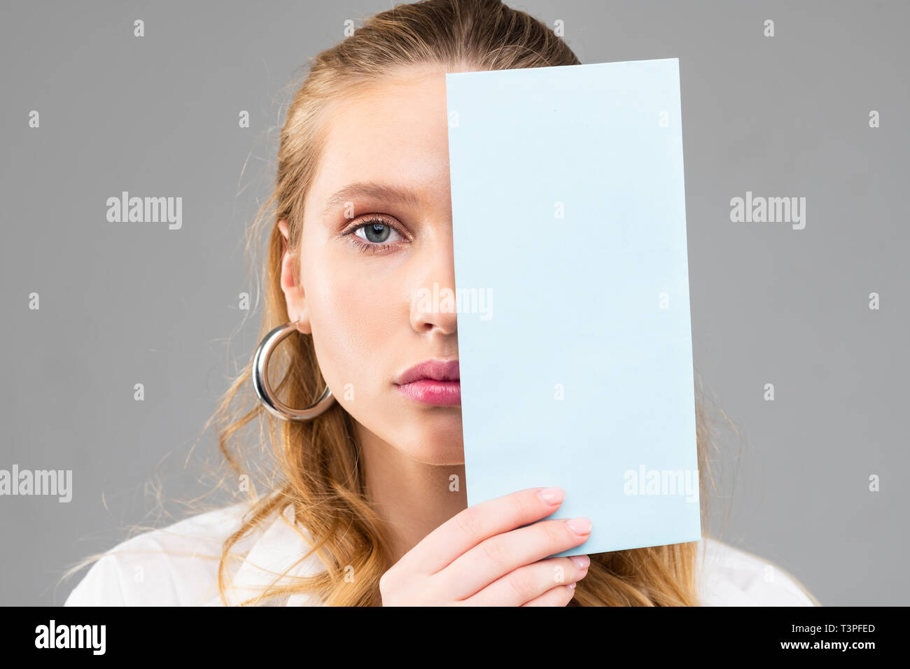 Emotionless long-haired female with blue eyes and pink lips Stock Photo