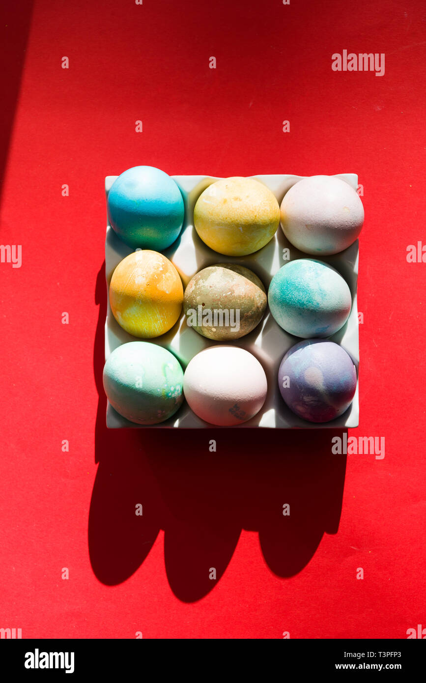 Colored eggs container, easter concept, hard natural direct light Stock Photo
