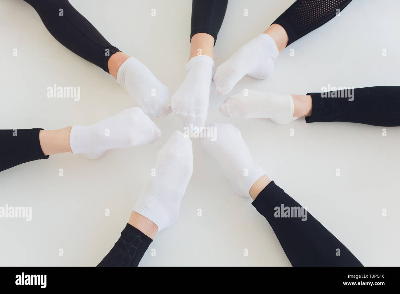 Ballet dancer tying ballet shoes. Close up ballet girl putting on her