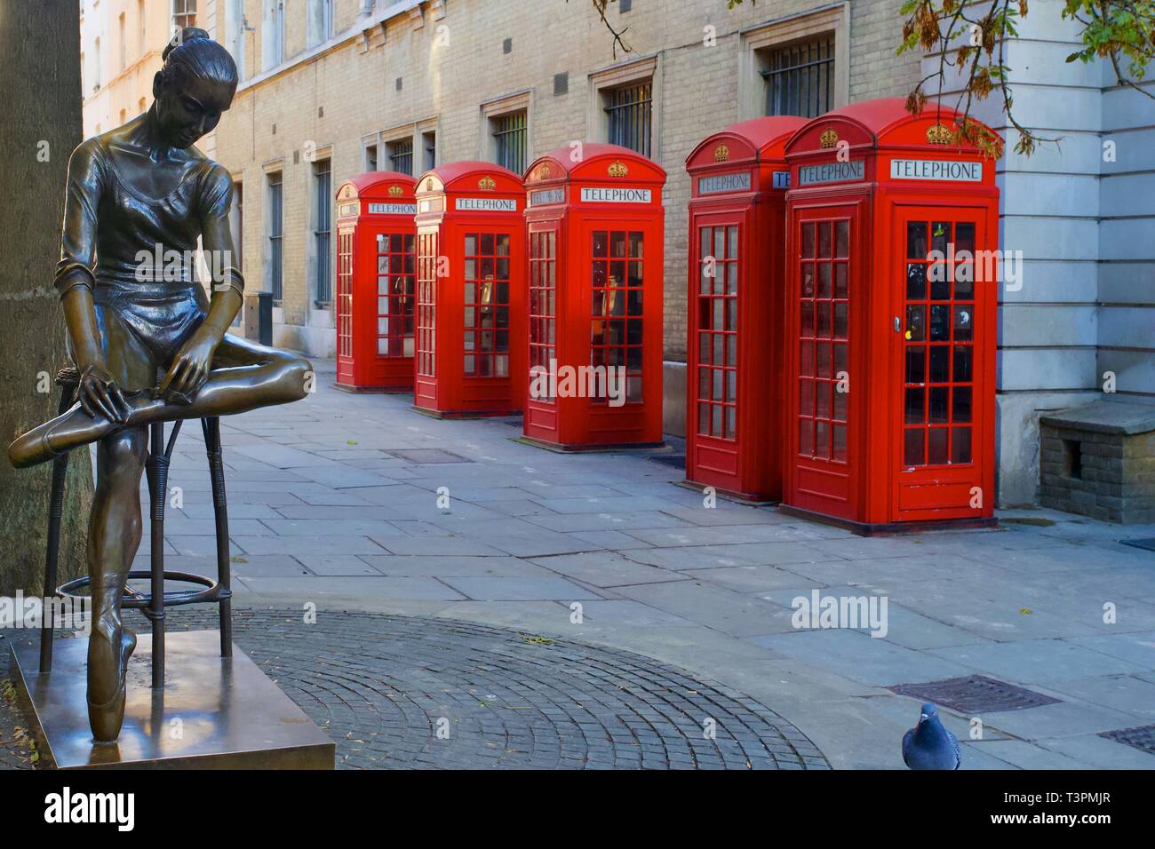 Red Telephone Boxes and statue of Dame Ninette de Valois by Enzo Plazzotta outside the Royal Opera House, Covent Garden, London, England. Stock Photo