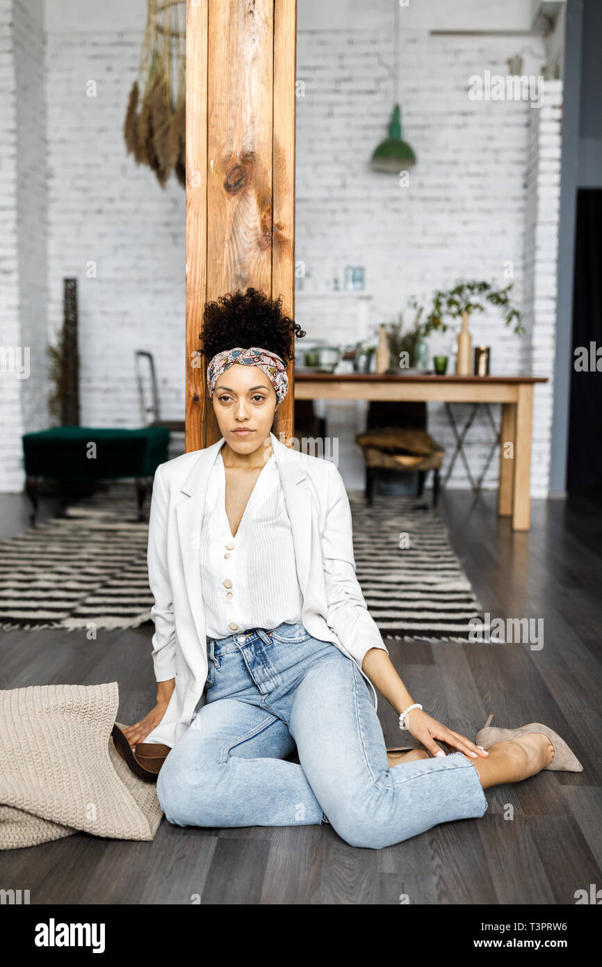 Young beautiful woman at home sitting on the floor Stock Photo - Alamy