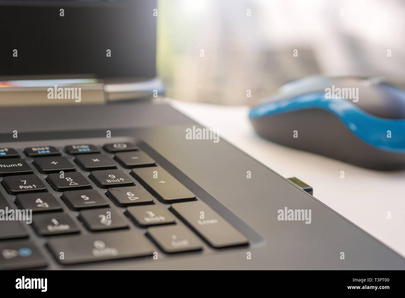 Number pad on a notebook with wireless mouse Stock Photo