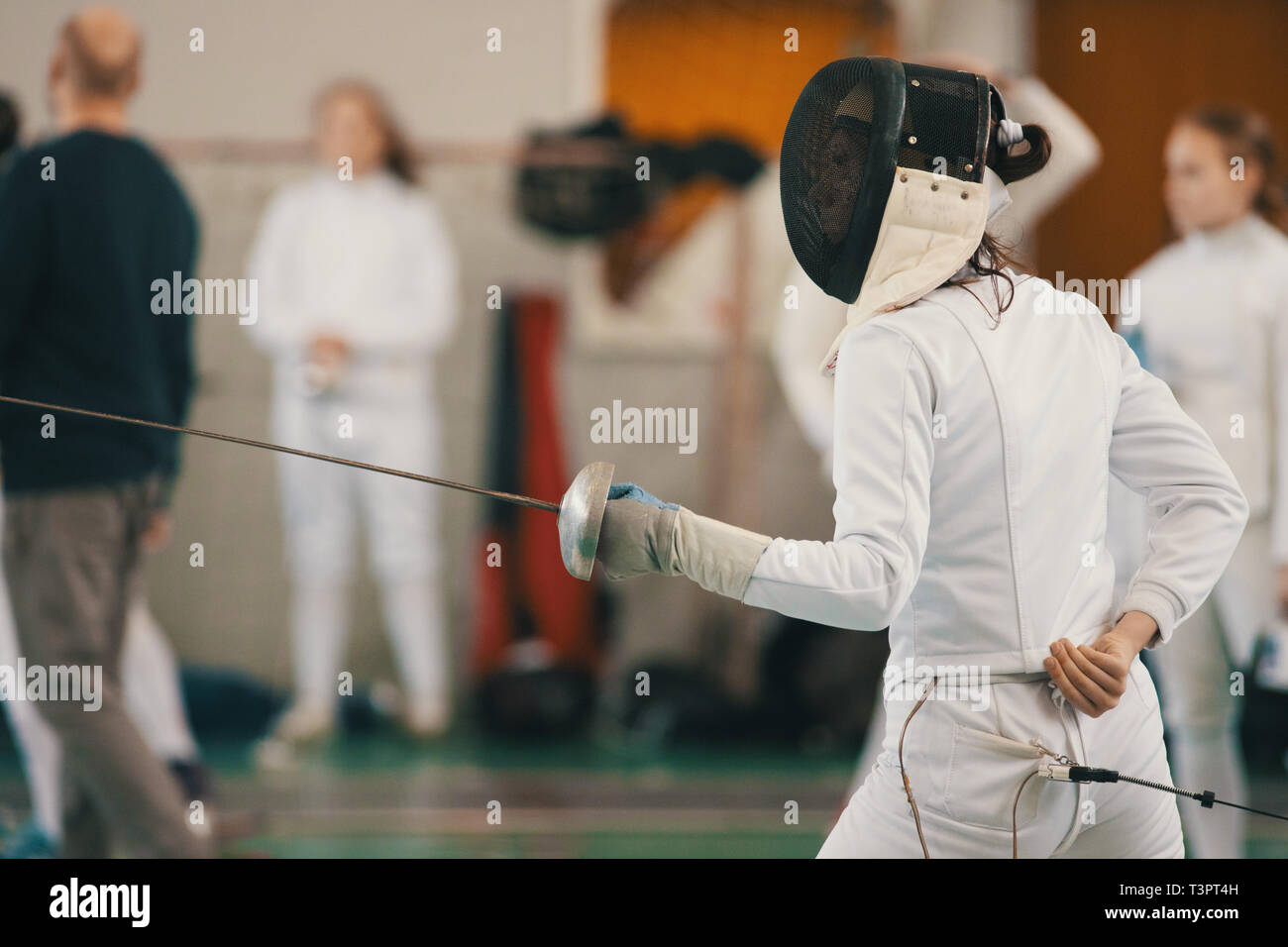 Young people fencers standing in the hall on a fencing tournament Stock
