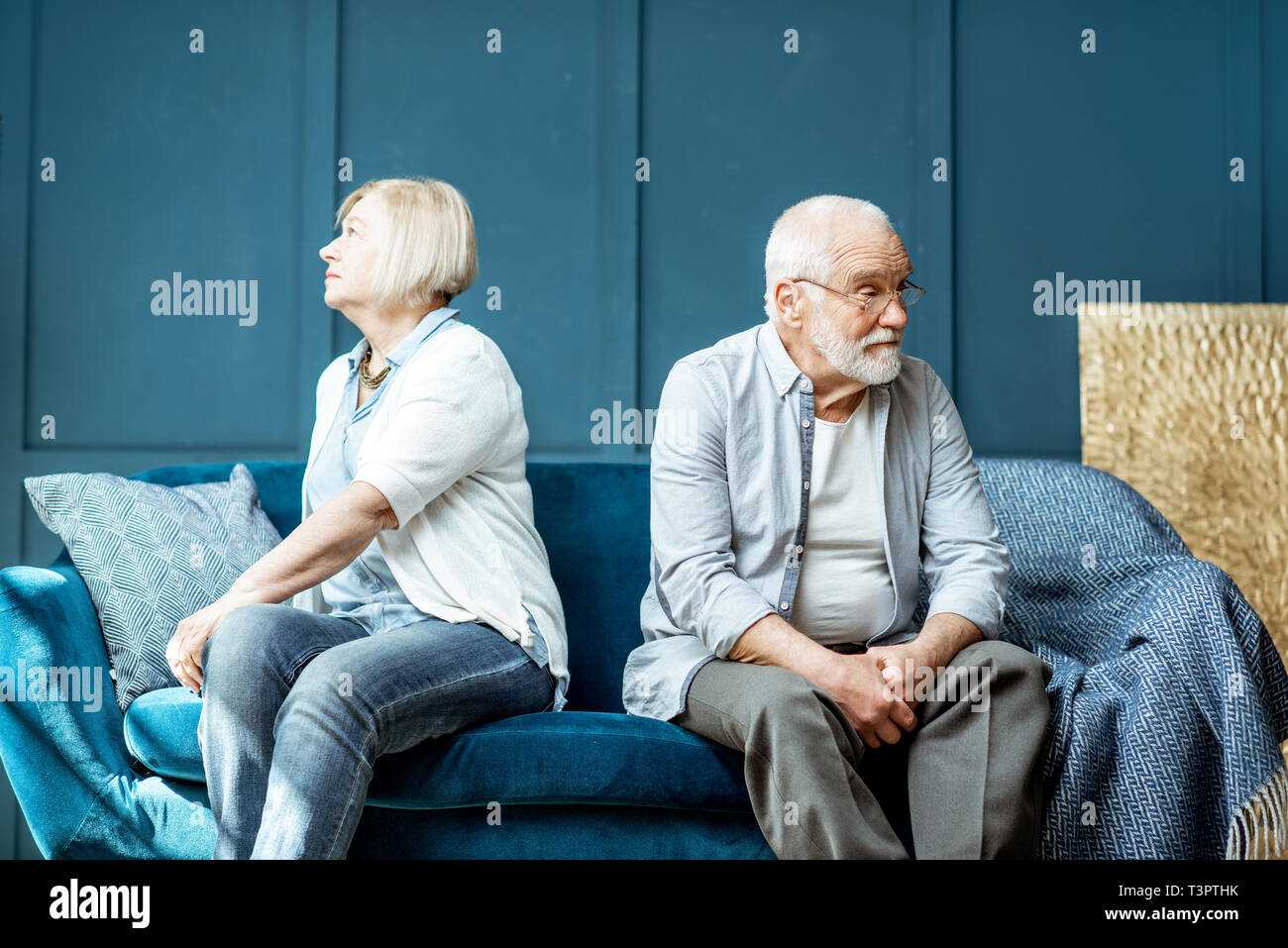 Offended senior man and woman feeling sad, sitting back to each other ...