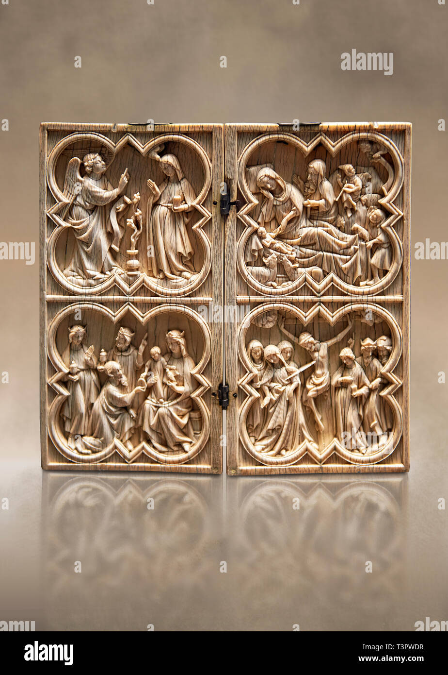 Medieval Gothic ivory diptych depicting the Annunciation, Nativity, the adoration of the Magi and the crucifixion  made in Paris in second quarter of  Stock Photo