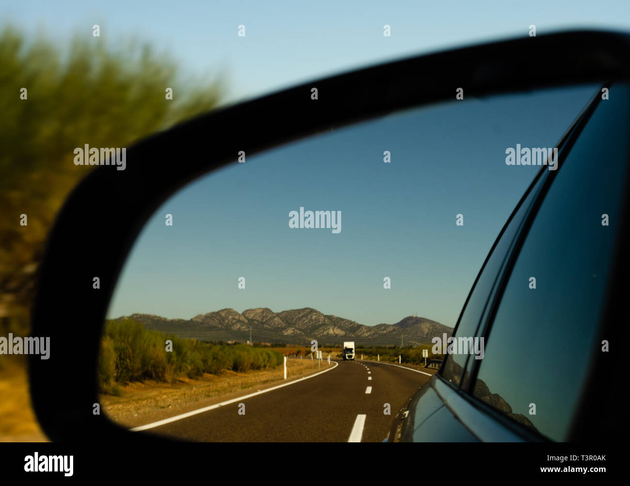 view in the car mirror on fast road in the Spain, beautiful landscape, transportation Stock Photo