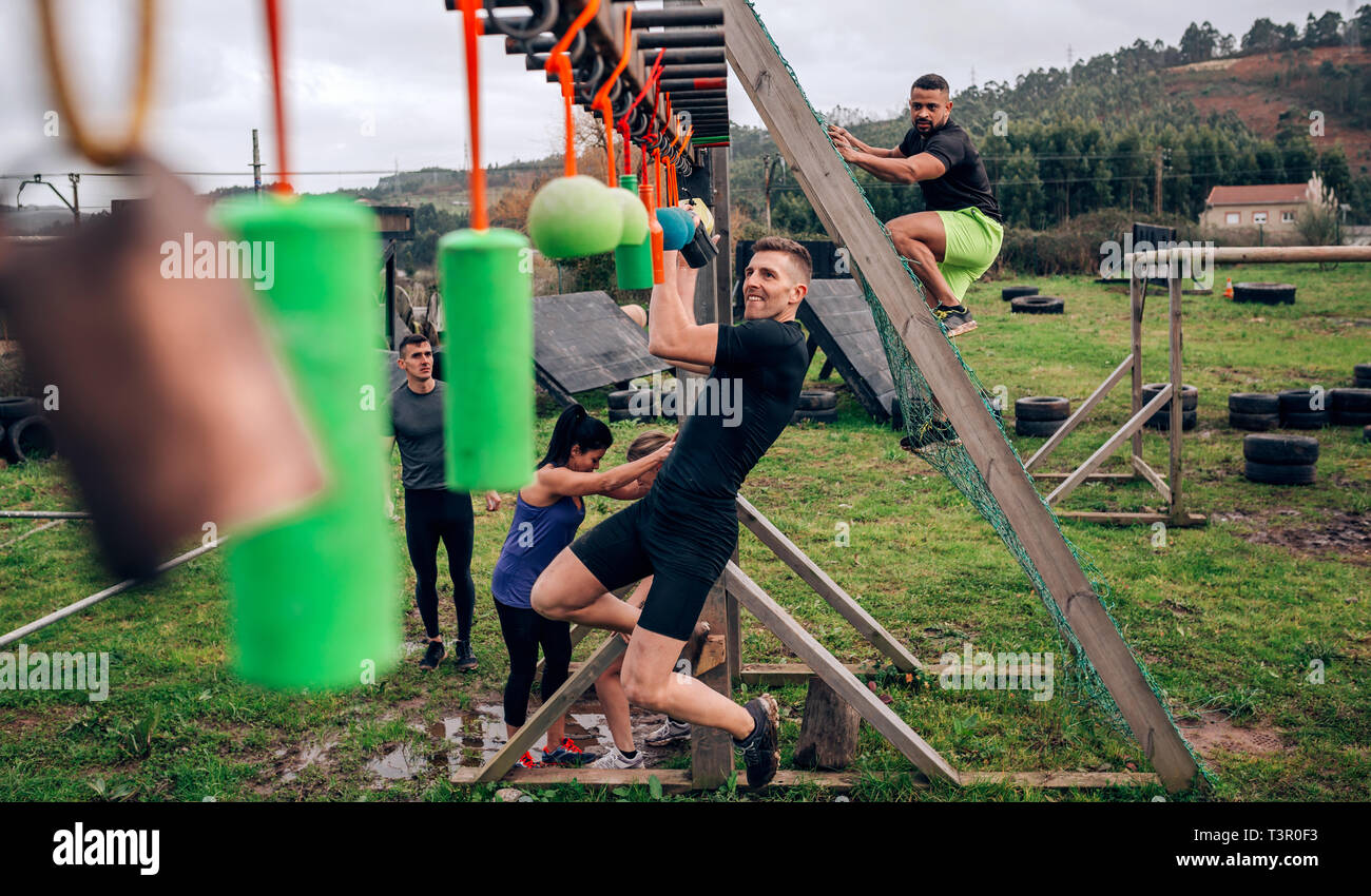 Participant obstacle course doing suspension Stock Photo Alamy