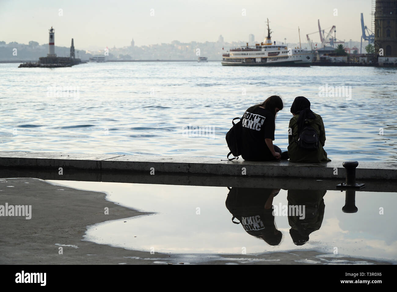 Istanbul, Turkey - September 6, 2018 :  Friendship of two young Turkish Women, one of them is wearing a t-shirt and writing don't panic. Stock Photo