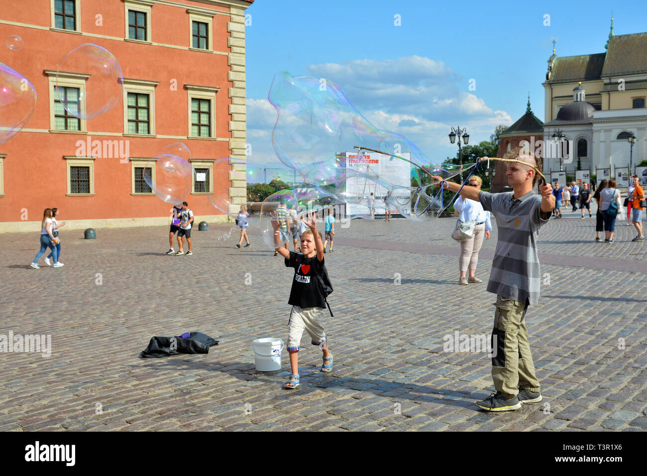 Playing with the soap bubbles in the Old Town Stare Miasto Warsaw, Castle Square, Poland's capital. Stock Photo