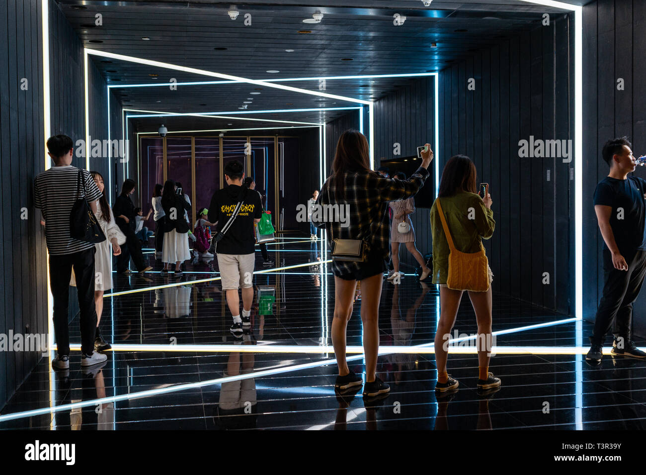 Visitors posing for pics and selfies inside trendy 'art cube' in Shenzhen China Stock Photo