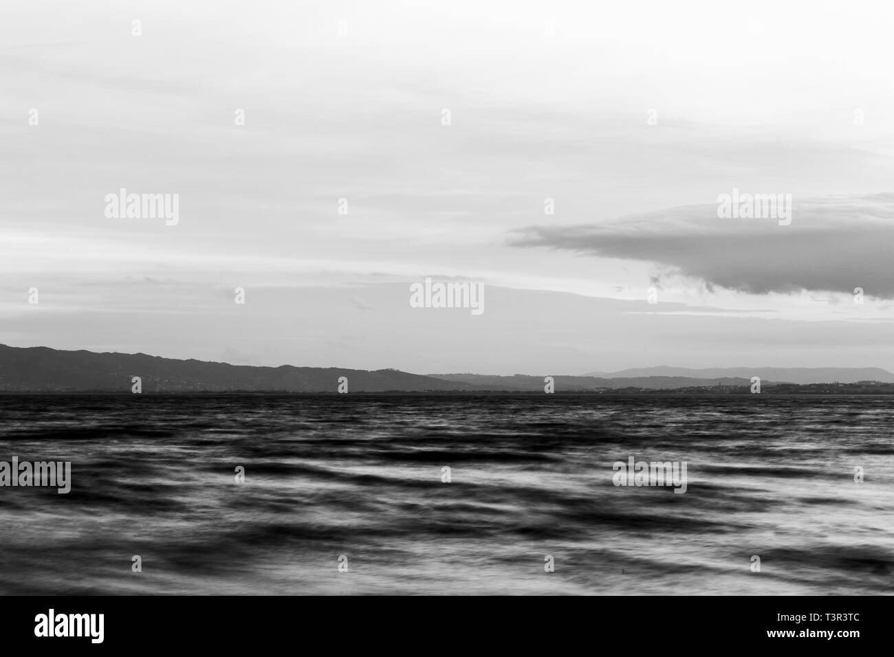 Close view of moving waves on a lake at dusk Stock Photo