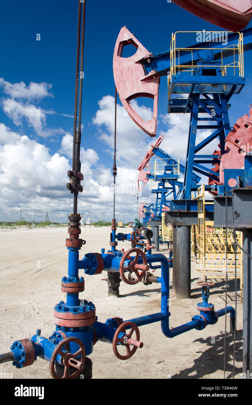 Oil and gas industry. Work of oil pump jack on a oil field. Oil latch on a pipeline Stock Photo