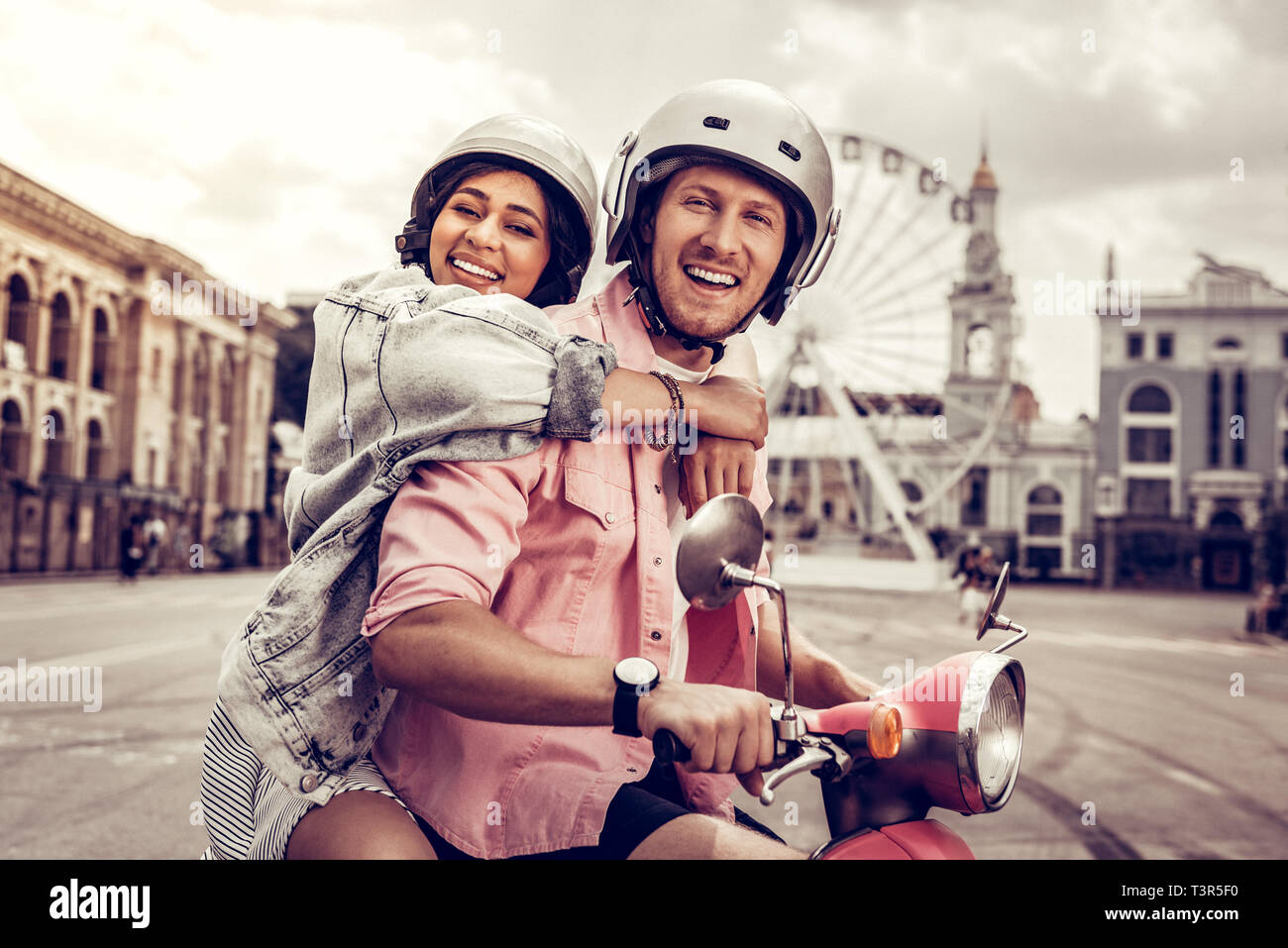 Positive delighted young woman hugging her boyfriend Stock Photo - Alamy