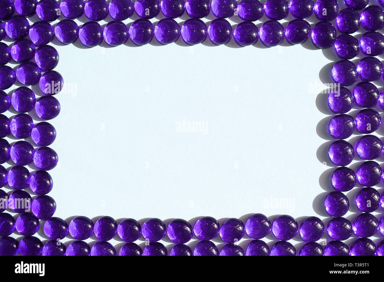 A Frame of Clear Purple Glass Pebbles Stock Photo Alamy