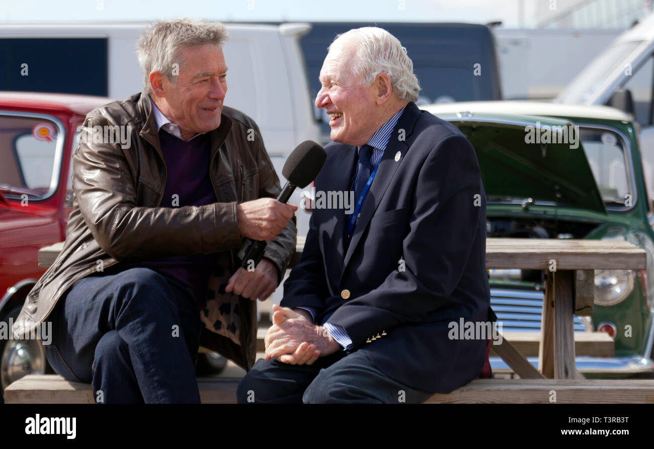 Tiff Needell interviewing mini rallying  legend Paddy Hopkirk MBE, in the International Paddock, during the Silverstone Classic Media Day 2019 Stock Photo