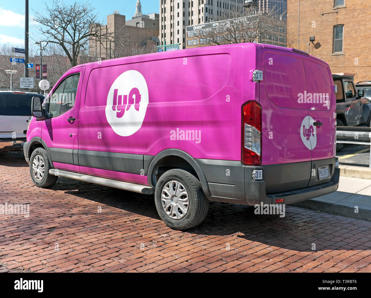 Pink Lyft van parked in downtown Cleveland, Ohio at the pick-up/drop-off point for riders Stock Photo