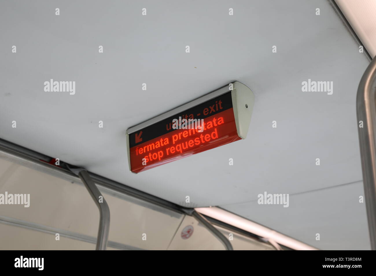 light signal with italian text FERMATA PRENOTATA that means Stop request in italian language on the tram of the city Stock Photo