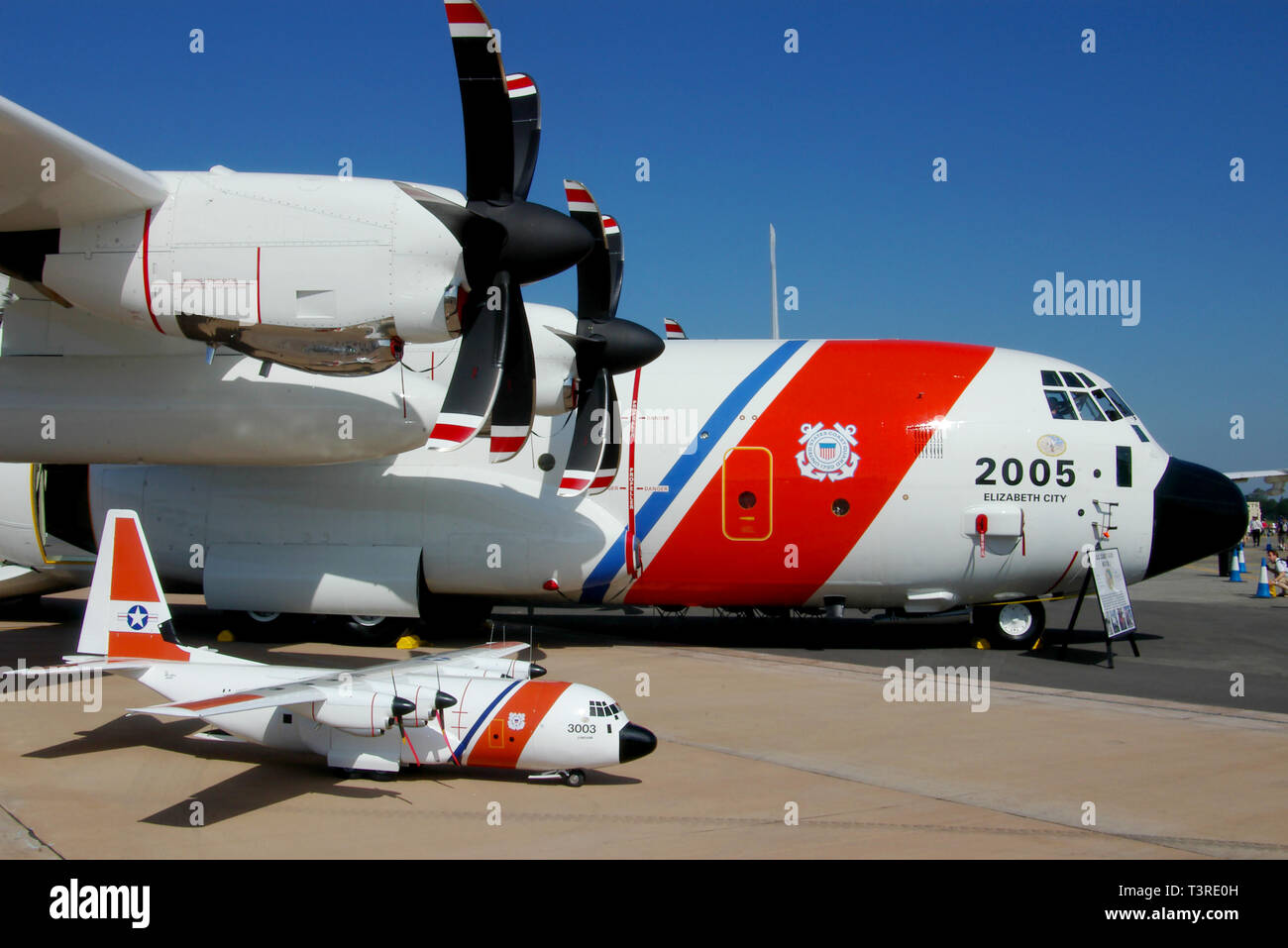 United States Coast Guard Lockheed HC-130J Hercules transport plane with similar model plane on display at RAF Fairford airshow. Space for copy Stock Photo