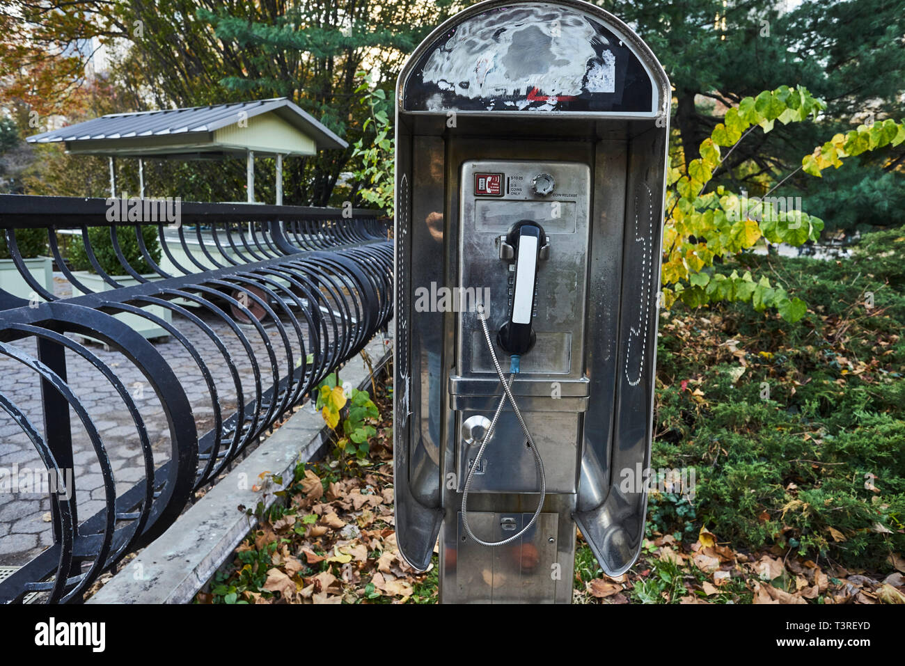 non working Telephone booth in Central Park Stock Photo