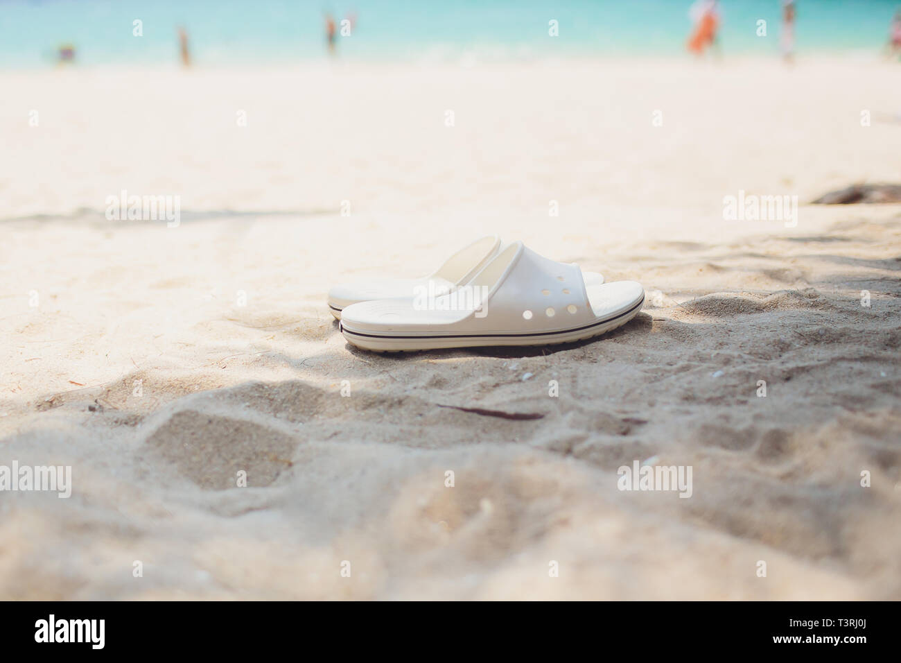 Summer vacation concept. Flip flops on a sandy ocean beach Stock Photo ...