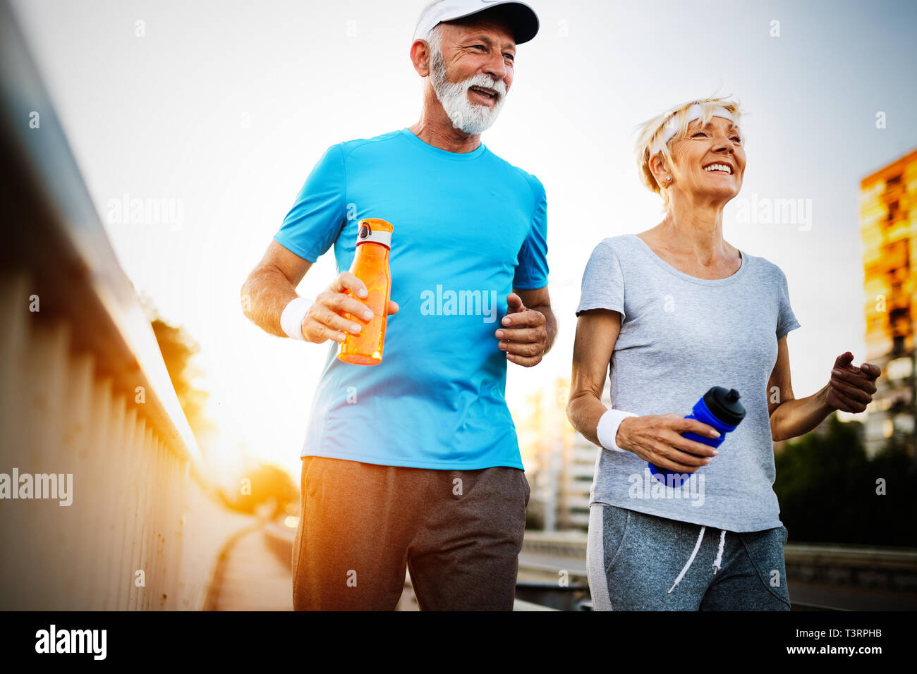 Happy senior couple staying fit by sport running Stock Photo