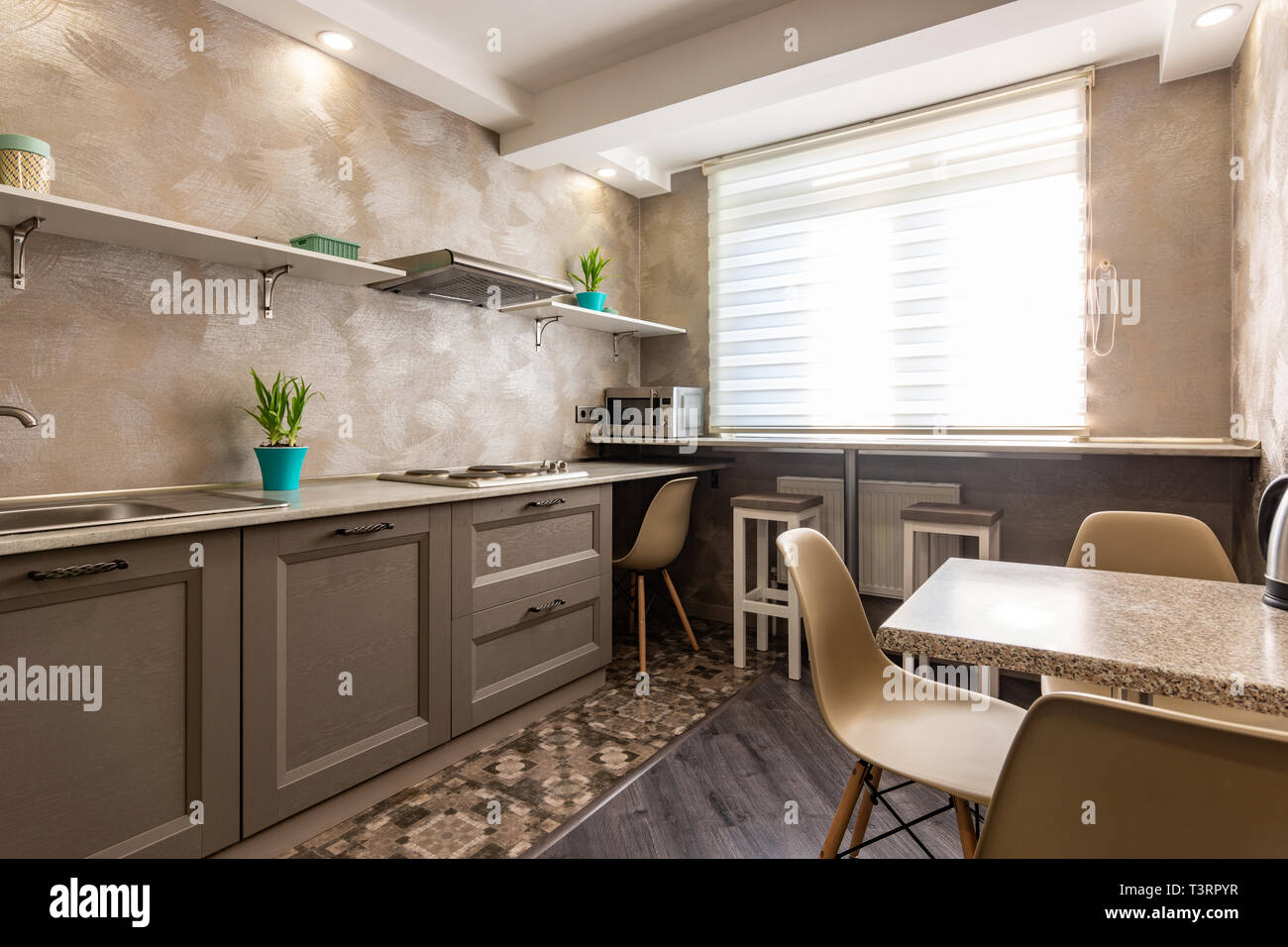 White kitchen machine and stand mixer on a wooden table in a bright design  apartment Stock Photo - Alamy