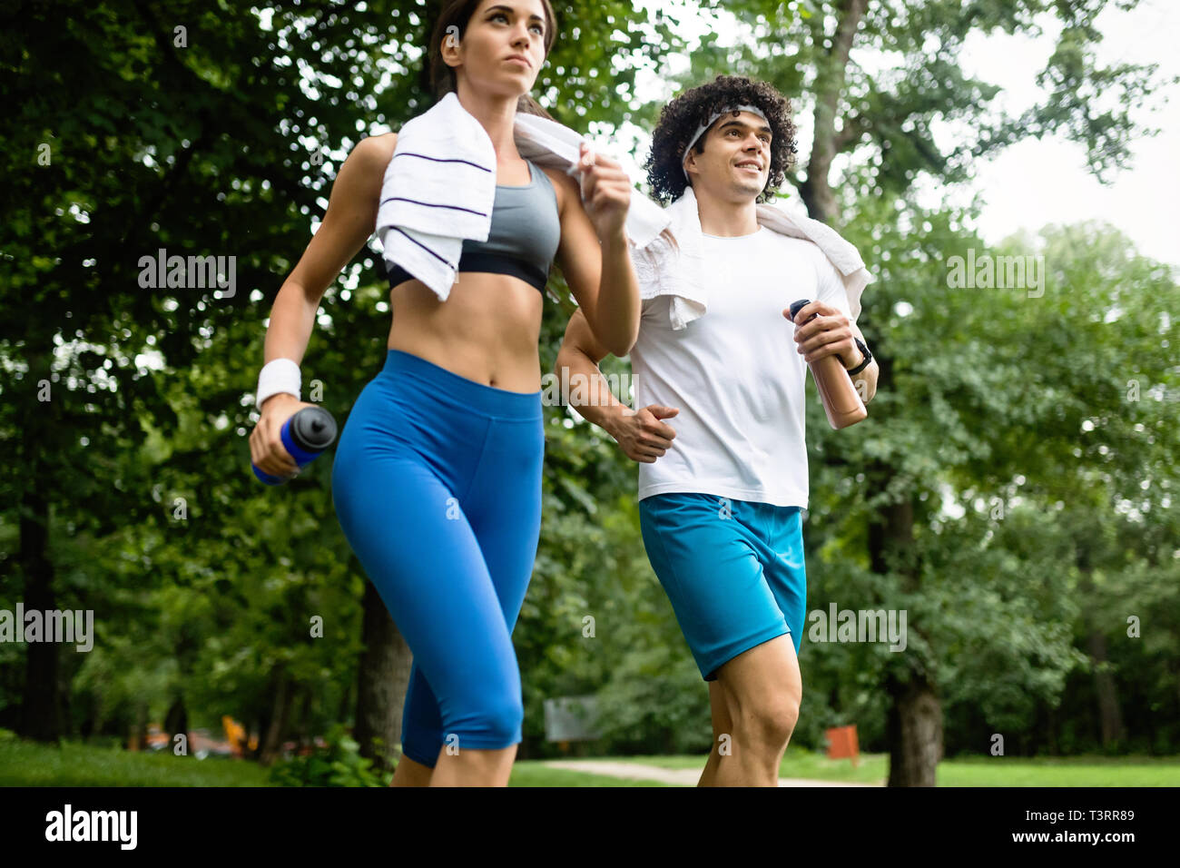 Beautiful couple jogging in nature living healthy Stock Photo - Alamy