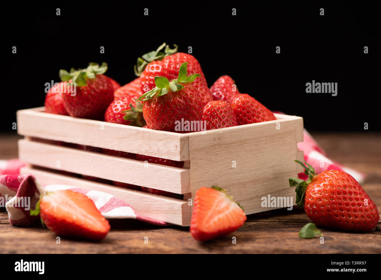 Fresh strawberries in a basket on old wooden table close up Stock Photo ...