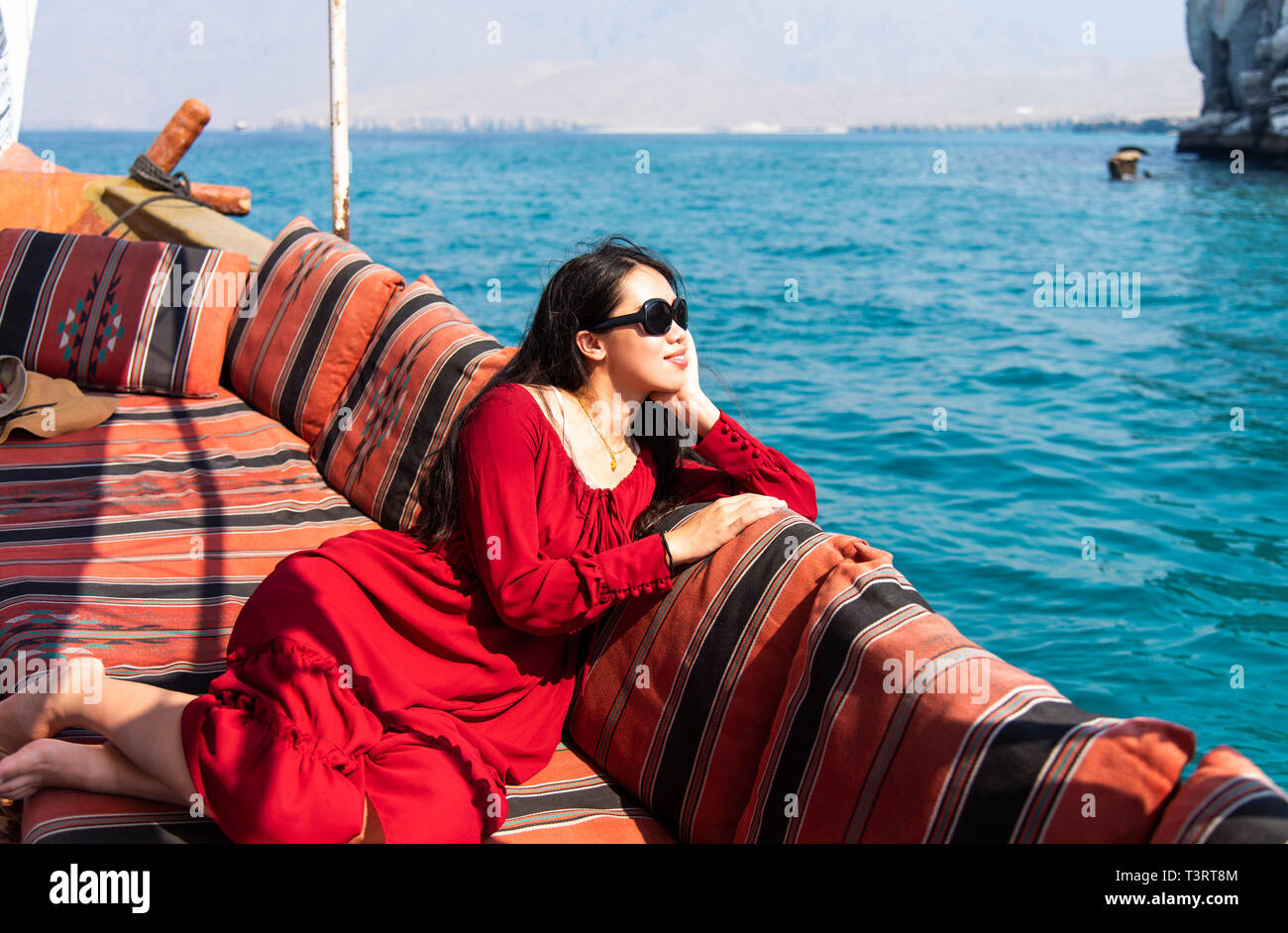 Woman having fun on a dhow boat cruise ride Stock Photo