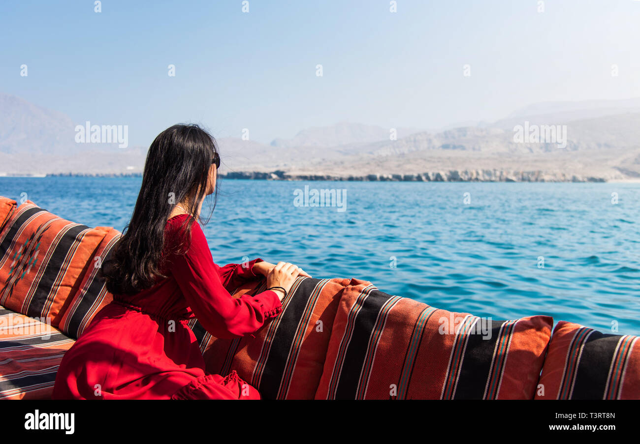 Woman having fun on a dhow boat cruise ride Stock Photo
