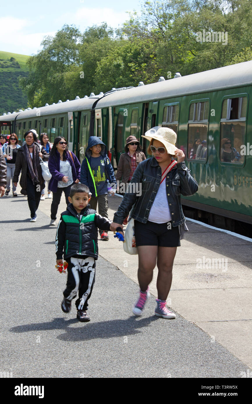 Families disembarking a heritage train in Corfe Castle Station in Dorset, UK. Stock Photo
