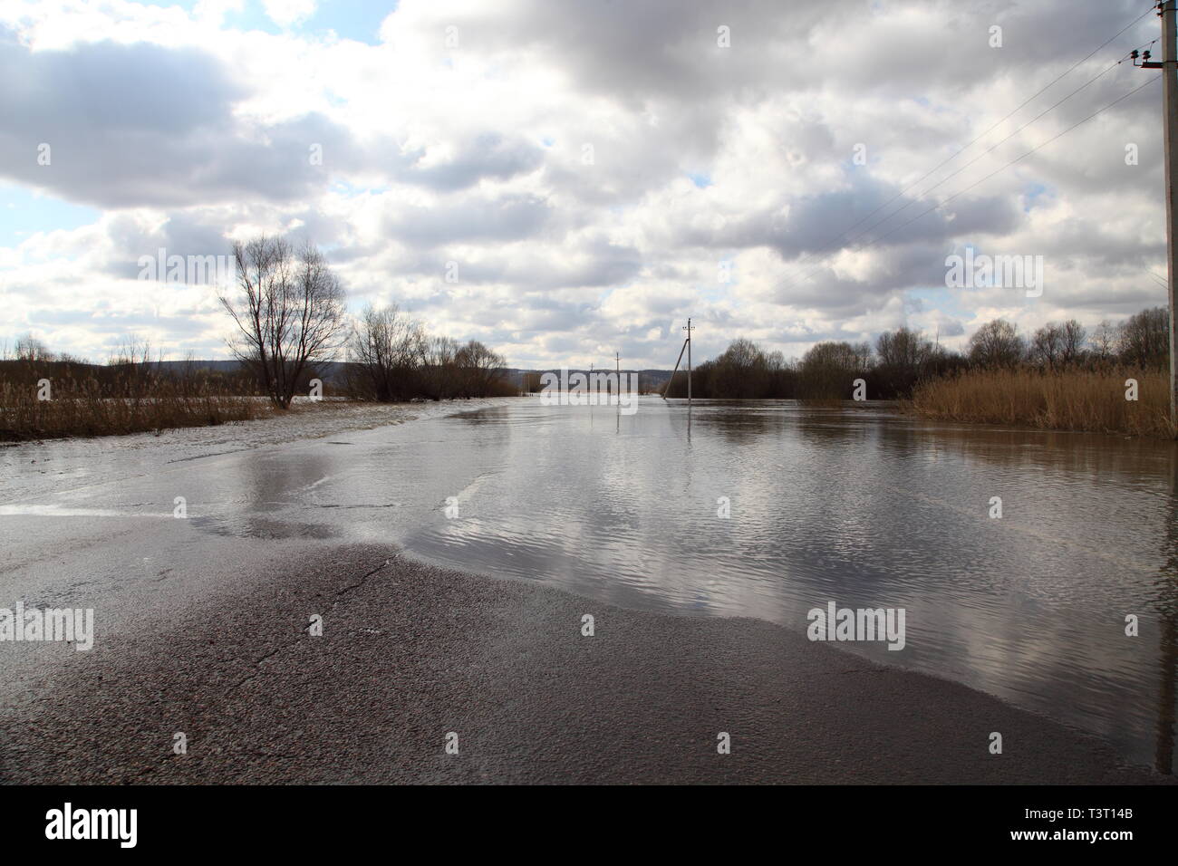 Water flooded the road. Spring flood of the river Stock Photo - Alamy