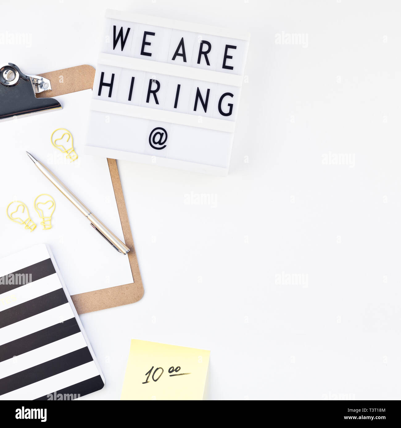 Creative top view flat lay of desk with we are hiring text on lightbox with  copy space on white background in minimal style. Concept of new job, hirin  Stock Photo - Alamy