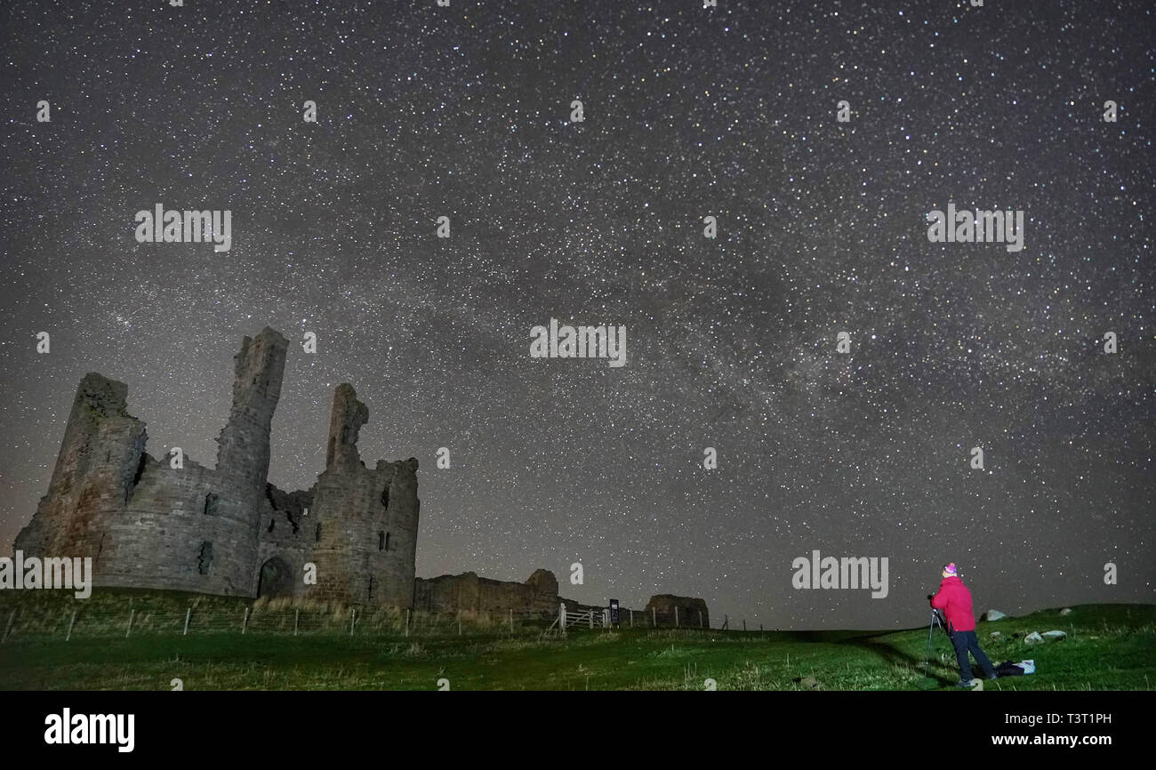 The Milky Way and millions of stars over Dinstanburgh Castle in the early hours of Thursday morning. Stock Photo