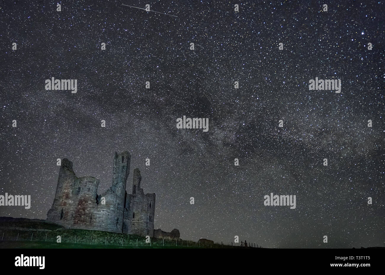 The Milky Way and millions of stars over Dinstanburgh Castle in the early hours of Thursday morning. Stock Photo