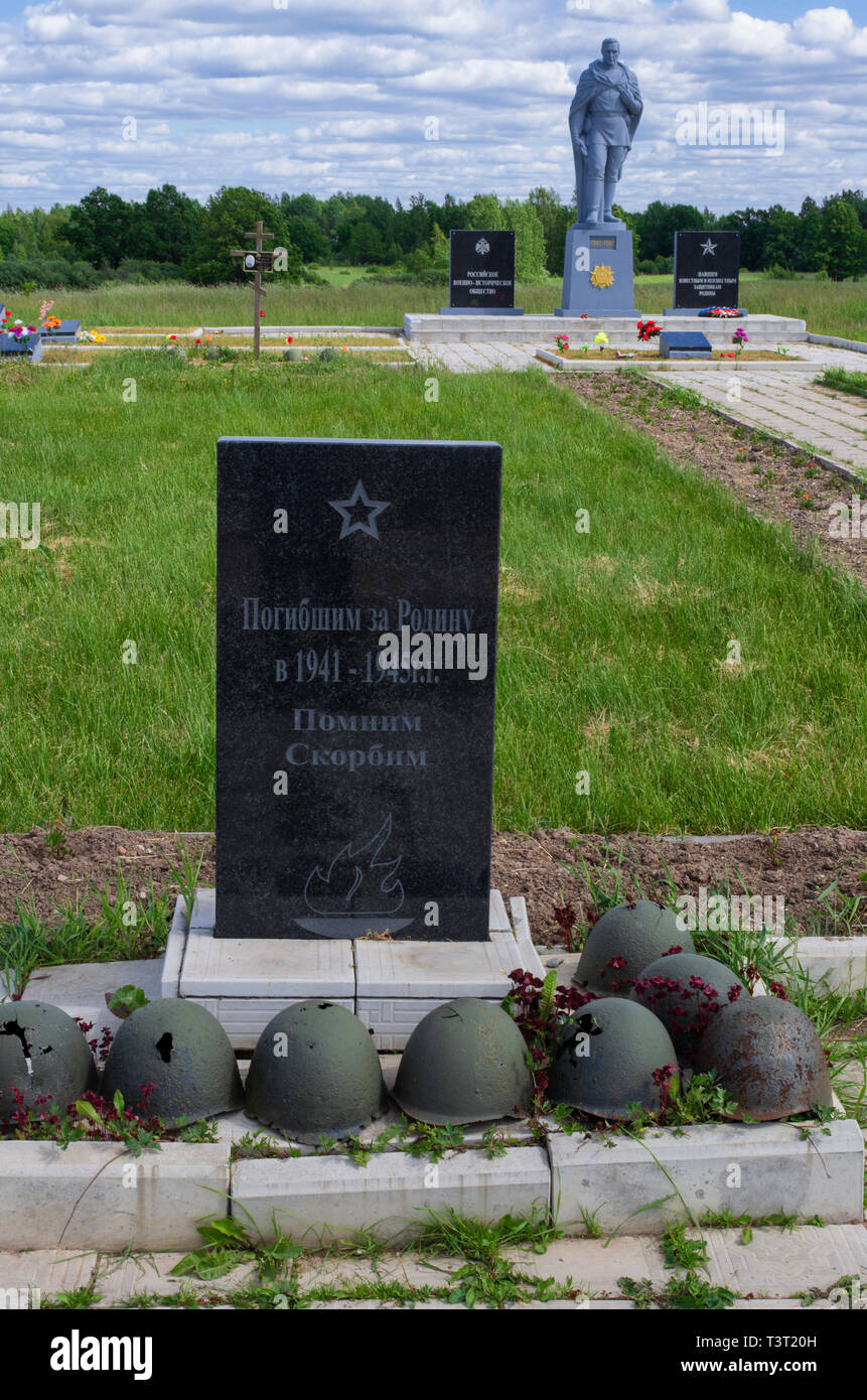 Combat helmets and russian inscription on memorial and a monument to the Soviet soldier at the Stalin line memorial (Pskov region,Russia) Stock Photo