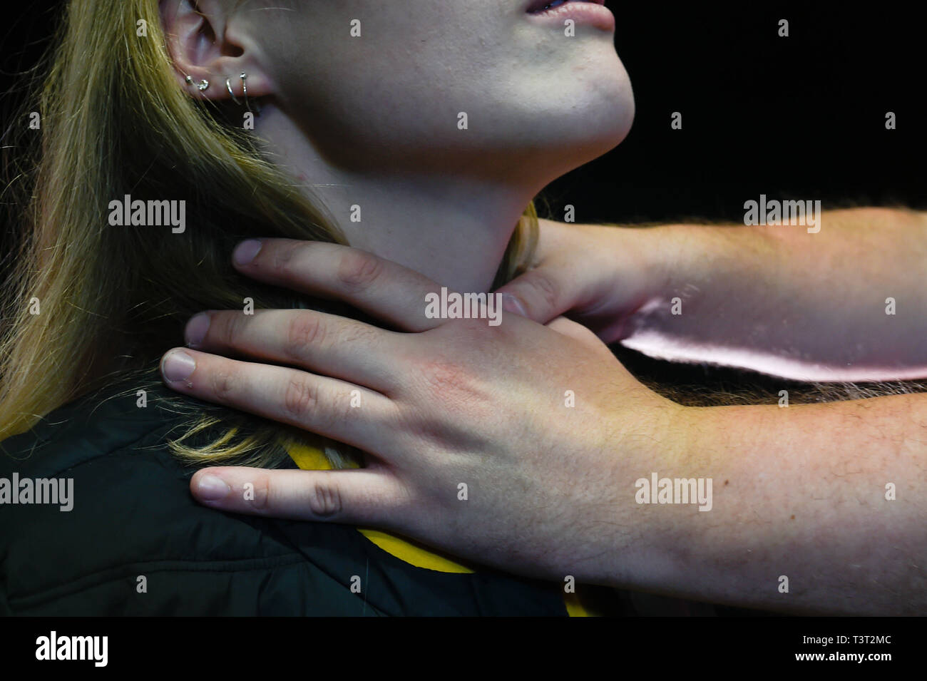 Domestic violence: man's hands choking a woman Stock Photo