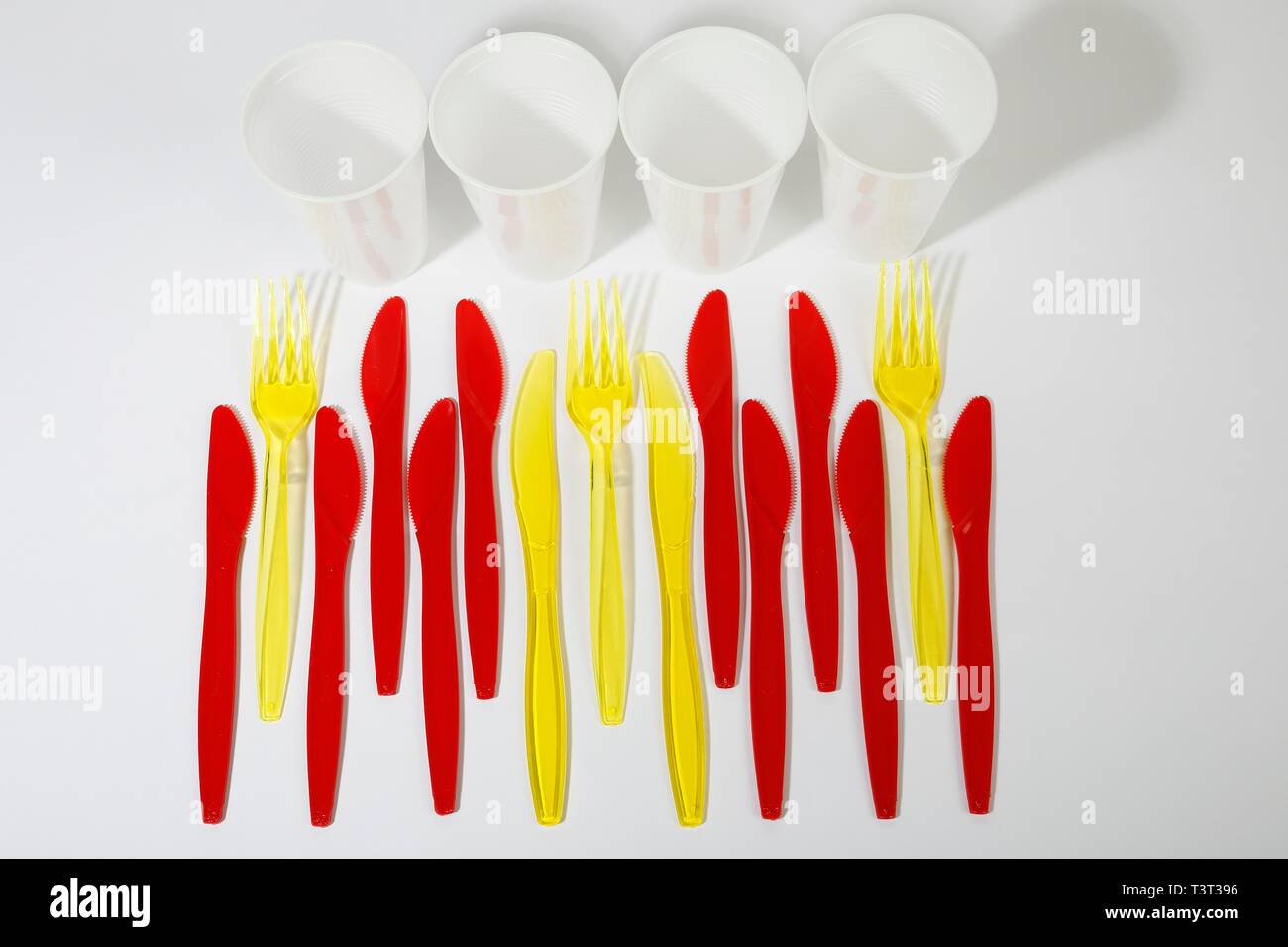 Red and yellow plastic cutlery, plastic knives, plastic forks, plastic cups, plastic waste, Germany Stock Photo