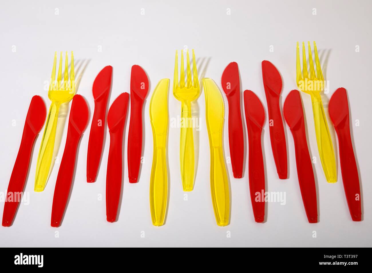 Red and yellow plastic cutlery, plastic knives, plastic forks, plastic waste, Germany Stock Photo