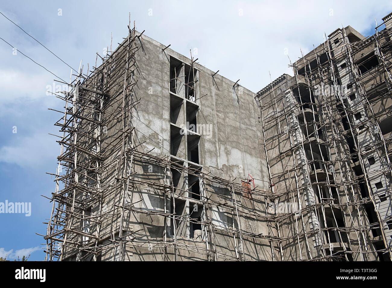 Shell construction with primitive scaffolding made of branches, Axum, Tigray, Ethiopia Stock Photo
