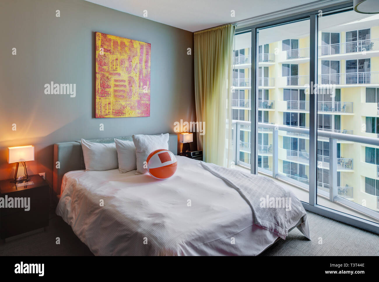 Beach ball on bed in hotel room Stock Photo Alamy
