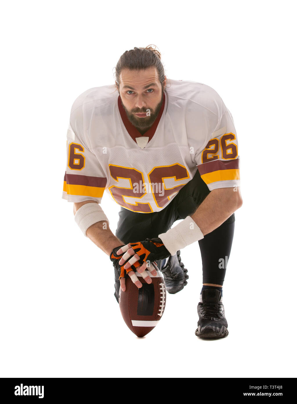 Bearded American football player sitting on his knee Stock Photo Alamy