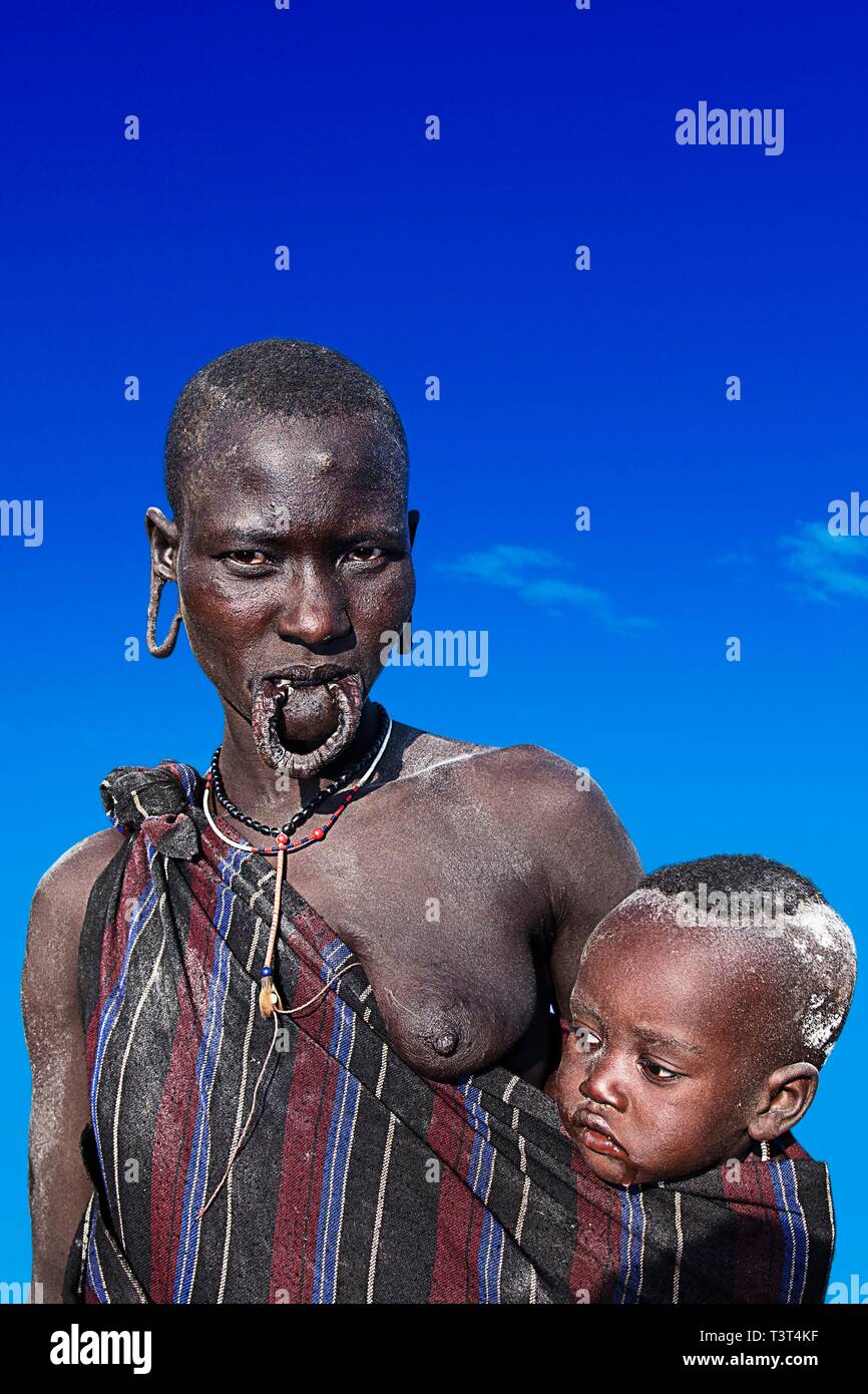 Woman with baby in sling, Mursi tribe, Mago National Park, Region of