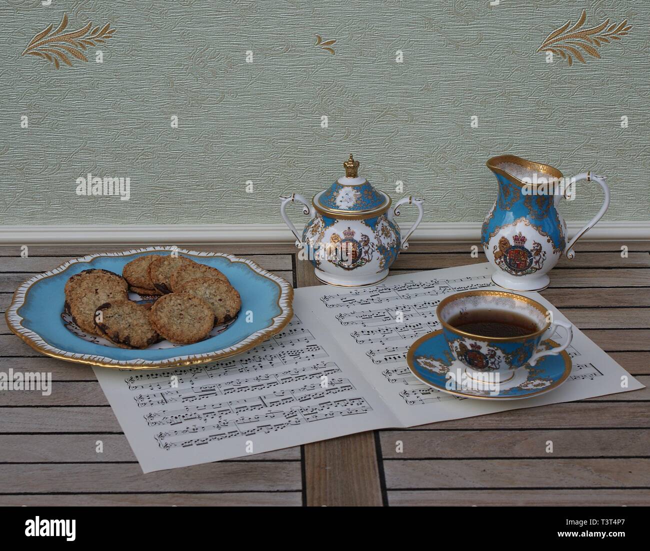 English teacup with saucer, sugar bowl, cream jug and a cake plate with