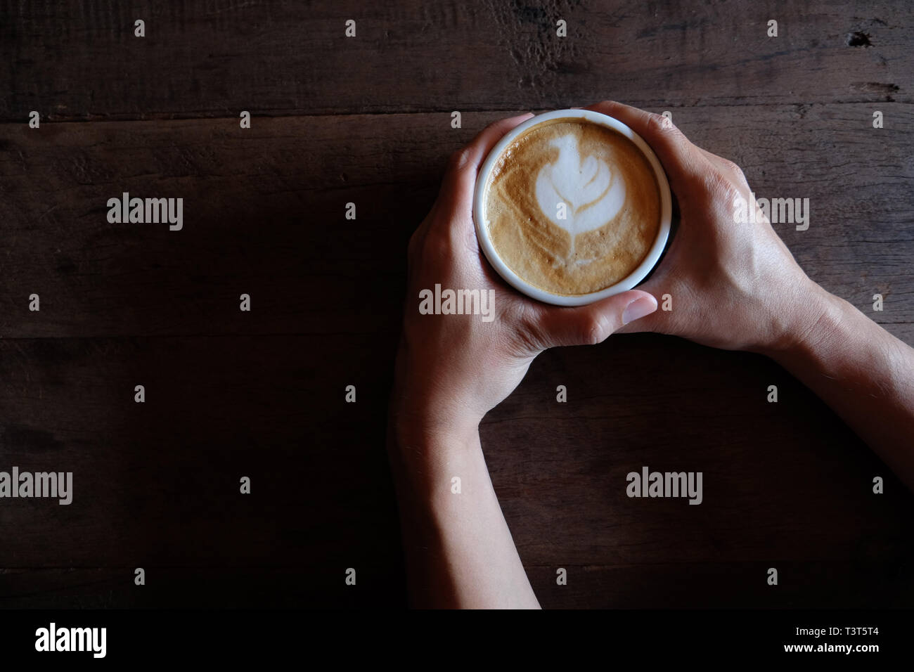 hands holding hot cup of coffee on rustic wooden table background Stock ...