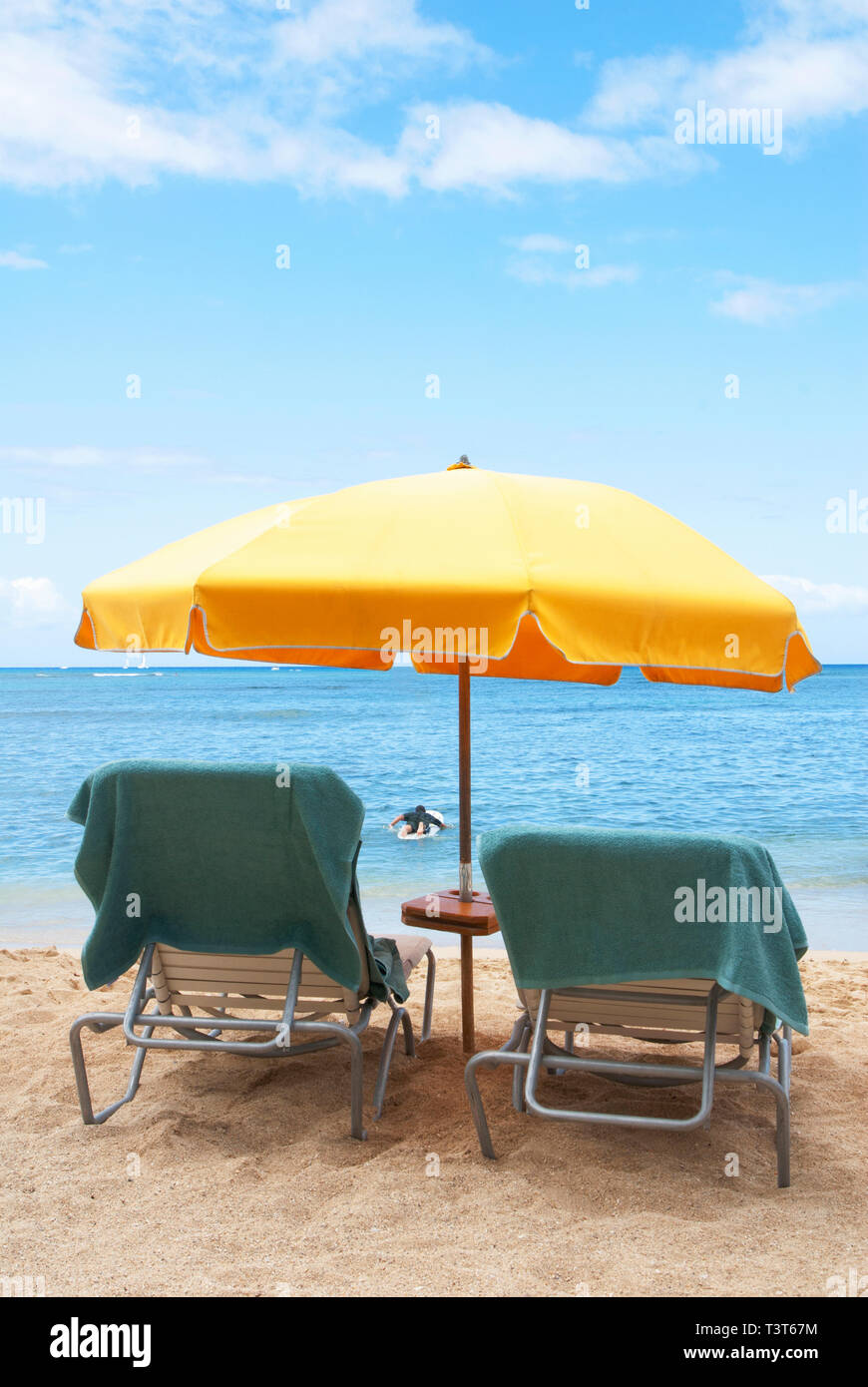 Lawn chairs and umbrella on beach Stock Photo - Alamy