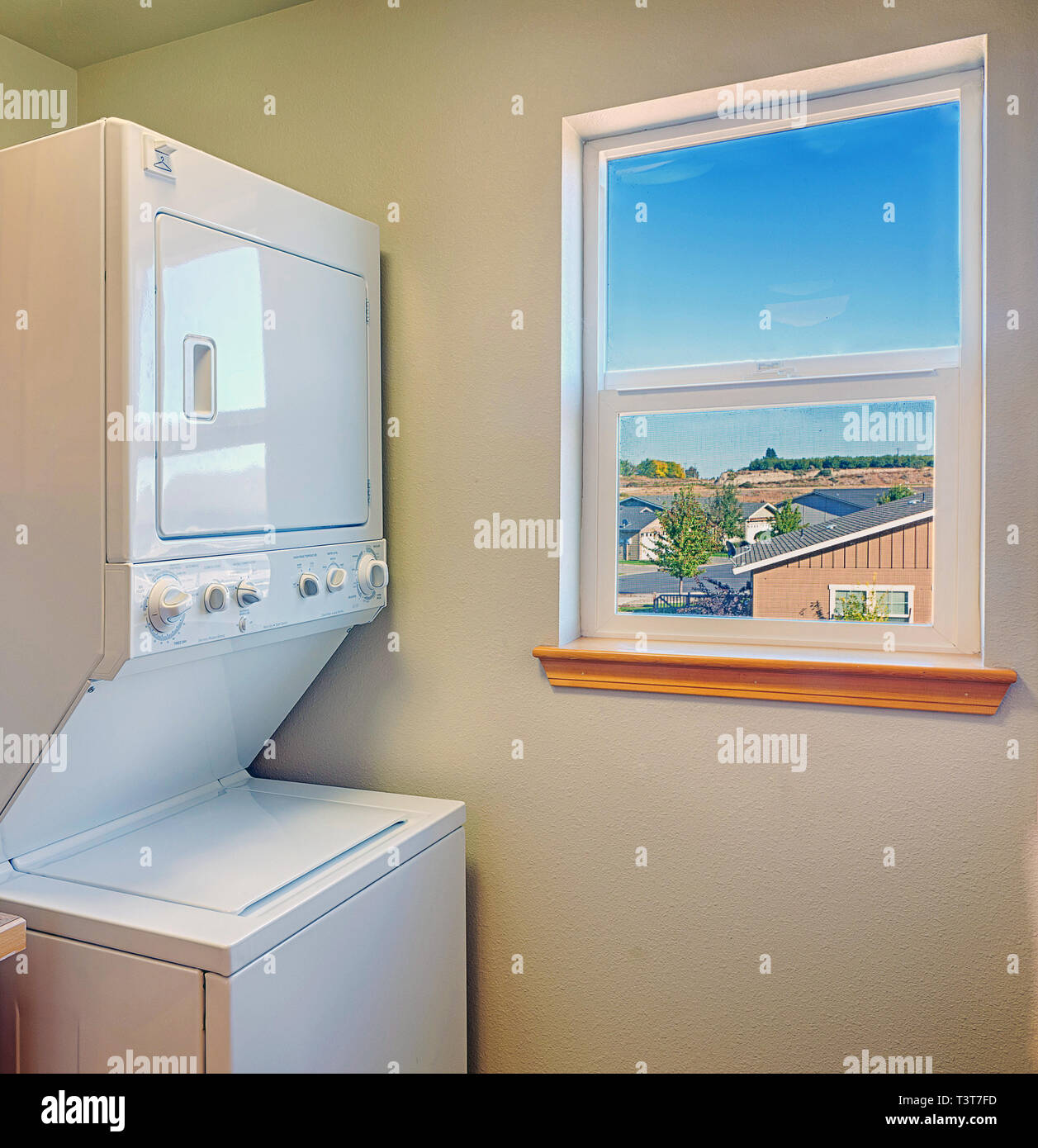 Washer and dryer with window in laundry room Stock Photo Alamy