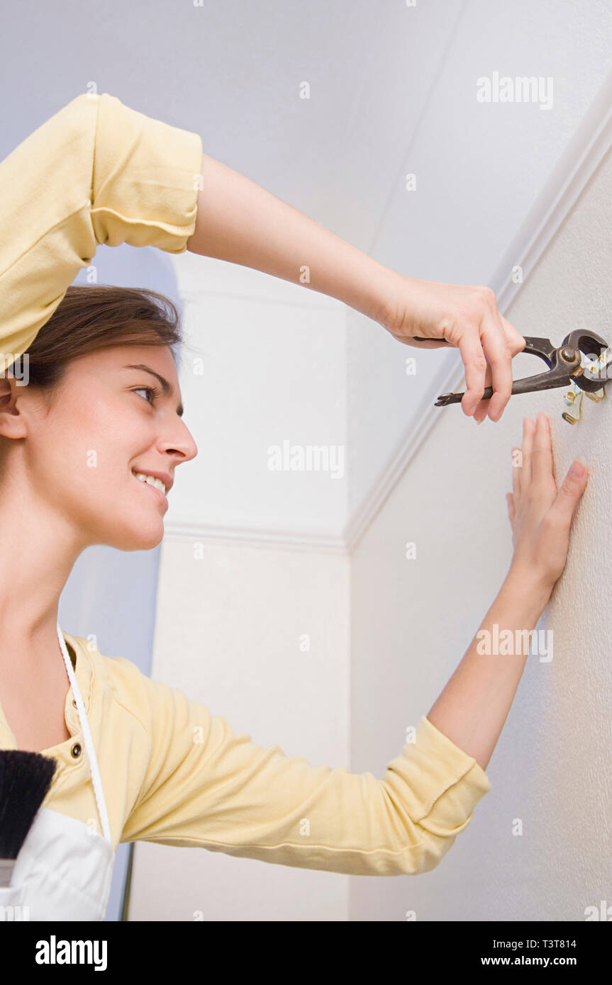 Caucasian woman doing home repair Stock Photo