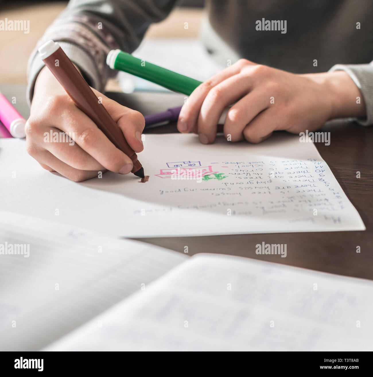 Caucasian boy drawing on paper Stock Photo